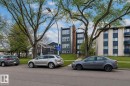 Modern multi-story building featuring dark gray siding and multiple large windows - #201 10743 107 St Nw, Edmonton, AB  - Outdoor 