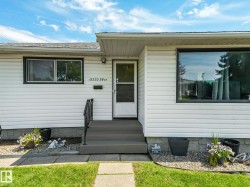 White vinyl siding exterior with dark framed windows - 