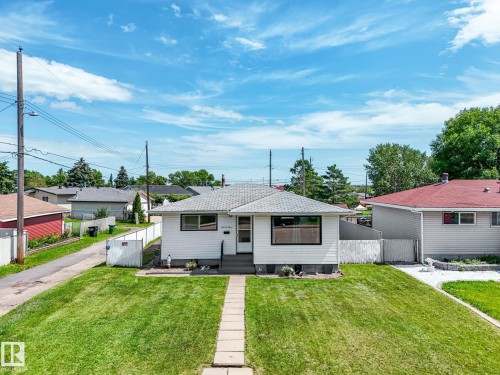 White siding exterior with black-trimmed windows - 13323 58 Street Nw, Edmonton, AB - Outdoor