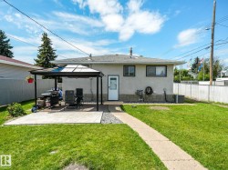 Manicured lawn with a concrete pathway leading to the rear entrance - 