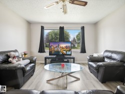 Living area featuring light wood-finish flooring and a central window - 