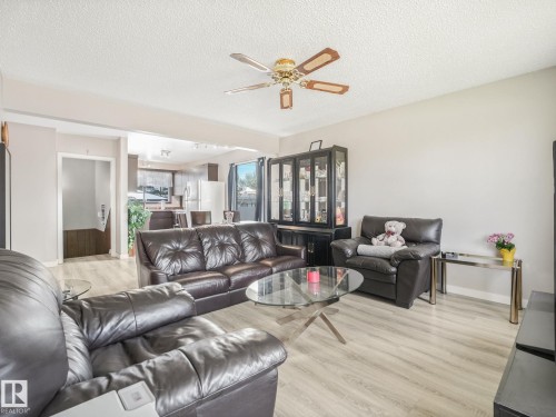 Open concept living area with light wood-finish flooring - 13323 58 Street Nw, Edmonton, AB - Indoor Photo Showing Living Room