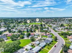 Aerial perspective showcasing a residential neighborhood with established homes, green spaces, and connecting roadways - 
