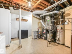 Utility area featuring a furnace and water heater - 