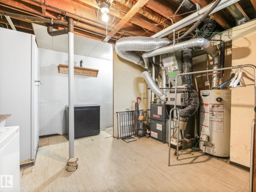 Utility area featuring a furnace and water heater - 13323 58 Street Nw, Edmonton, AB - Indoor Photo Showing Basement
