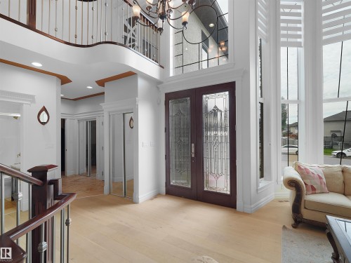Grand entryway featuring light wood-finish flooring and a double-height ceiling - 3136 35 Avenue Nw, Edmonton, AB - Indoor Photo Showing Other Room