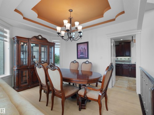 Dining area featuring a coffered ceiling with a painted center panel and a chandelier - 3136 35 Avenue Nw, Edmonton, AB - Indoor Photo Showing Dining Room