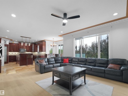 Open-concept living space featuring light wood-finish flooring, recessed lighting, and a modern ceiling fan - 3136 35 Avenue Nw, Edmonton, AB - Indoor Photo Showing Living Room