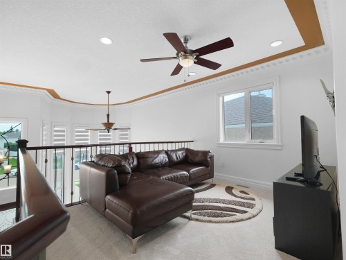 Loft area featuring high ceilings, decorative crown molding, recessed lighting, and a prominent ceiling fan - 3136 35 Avenue Nw, Edmonton, AB - Indoor