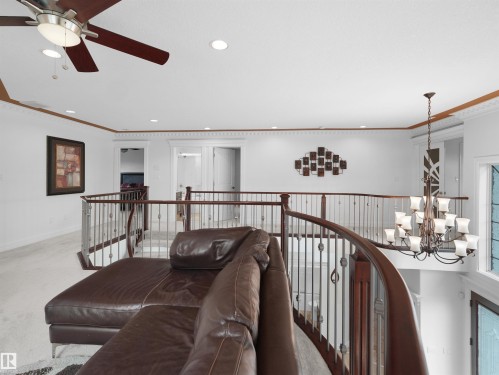 Upper-level landing featuring a wood and metal spindle railing, recessed lighting, and crown molding - 3136 35 Avenue Nw, Edmonton, AB - Indoor Photo Showing Other Room