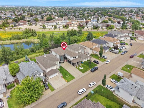 Expansive residential area featuring a distinct property with an attached garage, paved driveway, and mature landscaping - 3136 35 Avenue Nw, Edmonton, AB - Outdoor With View