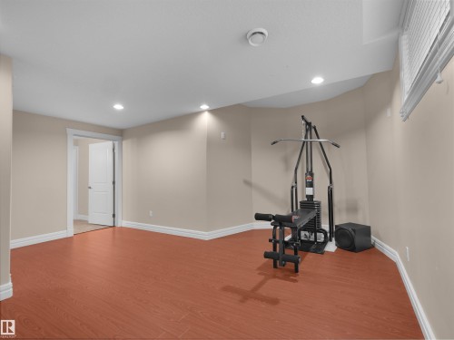 Spacious room featuring wood-finish flooring, recessed ceiling lighting, and neutral wall tones - 3136 35 Avenue Nw, Edmonton, AB - Indoor