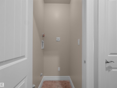 Dedicated utility space featuring neutral wall paint, tiled flooring, and white trim - 3136 35 Avenue Nw, Edmonton, AB - Indoor Photo Showing Other Room