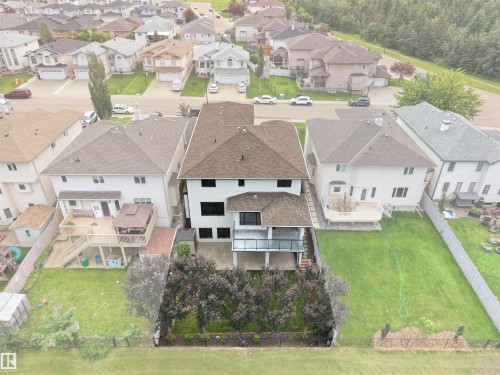 Two-story residence featuring a private backyard with mature trees, a multi-level deck, and a lower patio - 3136 35 Avenue Nw, Edmonton, AB - Outdoor With View