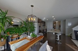 Open-concept living area featuring dark wood-finish flooring - 