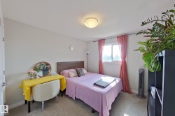 Bright room featuring a window with sheer pink drapes, light-colored walls, and a ceiling-mounted light fixture - 
