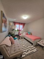 White walls and textured ceiling with flush-mount lighting - 