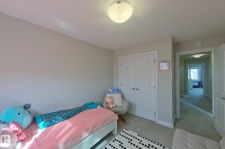 Carpeted room featuring light gray walls, a flush-mount ceiling light, and white bi-fold closet doors - 