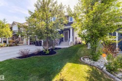 Two-story residence featuring dark siding and white trim - 