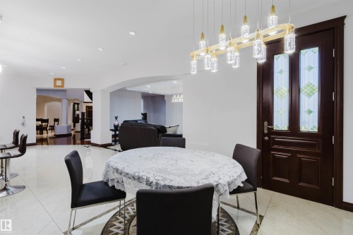 Modern entryway featuring a dark wood door with leaded glass panels - 4103 Westcliff Heath Heath Sw, Edmonton, AB - Indoor Photo Showing Dining Room