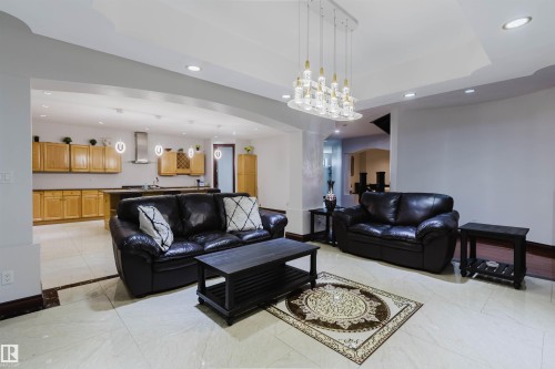 Open concept living area featuring light-toned tile flooring with dark border accents - 4103 Westcliff Heath Heath Sw, Edmonton, AB - Indoor Photo Showing Living Room