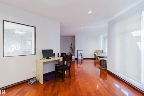 Rich wood-finish flooring complements crisp white walls - 4103 Westcliff Heath Heath Sw, Edmonton, AB - Indoor Photo Showing Office