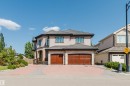 Two-story stucco and stone exterior featuring a multi-gabled roof and dark-framed windows - 4103 Westcliff Heath Heath Sw, Edmonton, AB  - Outdoor 
