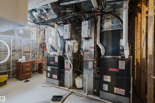 Utility room featuring multiple HVAC units and visible ductwork - 4103 Westcliff Heath Heath Sw, Edmonton, AB - Indoor Photo Showing Basement