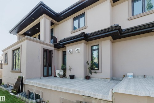 Exterior stucco finish with dark trim accents and a concrete patio - 4103 Westcliff Heath Heath Sw, Edmonton, AB - Outdoor With Exterior