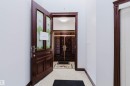 Entryway featuring a wood-panel door with decorative glass inserts, leading to an interior space with a recessed ceiling light - 4103 Westcliff Heath Heath Sw, Edmonton, AB  - Indoor Photo Showing Other Room 
