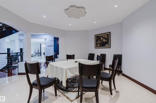Formal dining area featuring recessed lighting, a decorative ceiling medallion, and light-toned tile flooring with a central patterned inlay - 4103 Westcliff Heath Heath Sw, Edmonton, AB - Indoor Photo Showing Dining Room