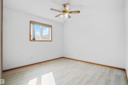 Bright room featuring light wood-finish flooring and white walls - 