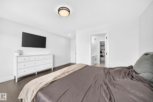 Bedroom featuring dark wood-finish flooring and white baseboards - 22270 99A Avenue Nw, Edmonton, AB - Indoor Photo Showing Bedroom