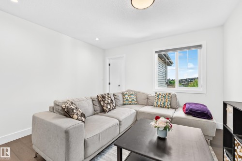 Bright room with white painted walls and dark wood-finish flooring - 22270 99A Avenue Nw, Edmonton, AB - Indoor Photo Showing Living Room