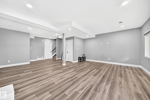 Spacious lower-level area featuring wood-finish flooring and recessed lighting - 22270 99A Avenue Nw, Edmonton, AB - Indoor Photo Showing Other Room