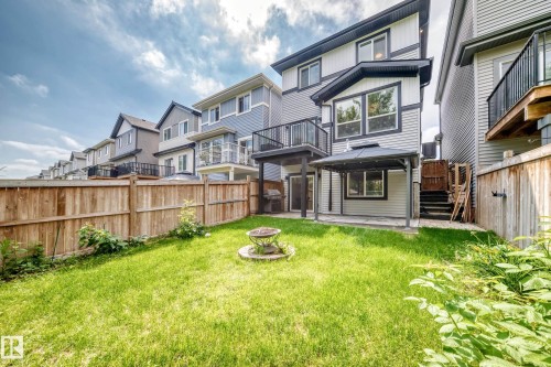 Expansive backyard featuring a manicured lawn, a fire pit, and a covered patio area with a gazebo - 22270 99A Avenue Nw, Edmonton, AB - Outdoor