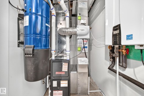 Integrated central vacuum system, Goodman furnace, humidifier, and tankless water heater - 22270 99A Avenue Nw, Edmonton, AB - Indoor Photo Showing Basement