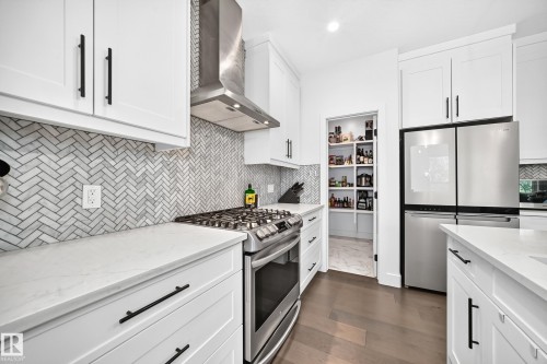 Modern kitchen featuring white cabinetry, stainless steel appliances, and quartz countertops - 22270 99A Avenue Nw, Edmonton, AB - Indoor Photo Showing Kitchen With Stainless Steel Kitchen With Upgraded Kitchen