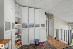 White built-in cabinetry with frosted glass panels and open shelving - 