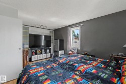 Room featuring a single window, track lighting, and built-in white cabinetry with frosted glass panels - 