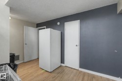 Light wood-finish flooring complements the contrasting wall colors of gray and off-white - 