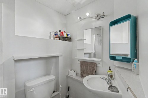 White ceramic wall-mounted sink with chrome faucet - 64 Pipestone, Devon, AB - Indoor Photo Showing Bathroom