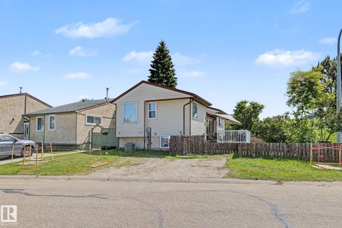 Siding exterior with a pitched roofline, surrounded by mature trees - 64 Pipestone, Devon, AB - Outdoor