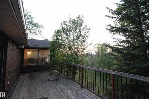 The large master bedroom easily supports king sized furniture, has a 3 piece ensuite, a walk in closet, and this private elevated deck, with an unimpeded view to into the ravine to the north - 4108 106B Avenue, Edmonton, AB - Outdoor