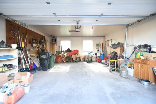 As if the 2500+ square feet on the main floor was not enough, the basement is larger still, thanks to the concrete storage room that was designed into the build, located UNDER the heated double garage.  Wine room anyone? - 4108 106B Avenue, Edmonton, AB - Indoor Photo Showing Garage