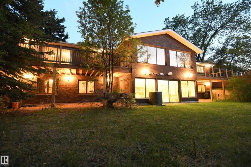 To call the setting private is an understatement.  3 bedrooms on the main floor, with 2 more plus an office on the walkout level.  4 sets of patio doors show how the ravine location invites you from the home, into the yard - 4108 106B Avenue, Edmonton, AB - Outdoor