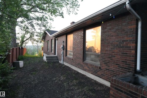 The large windows on the ravine facing side of the home continue along the west side, including the garage, providing outstanding natural light - 4108 106B Avenue, Edmonton, AB - Outdoor