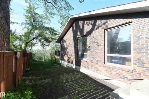 The large windows on the ravine facing side of the home continue along the west side, including the garage, providing outstanding natural light - 4108 106B Avenue, Edmonton, AB - Outdoor