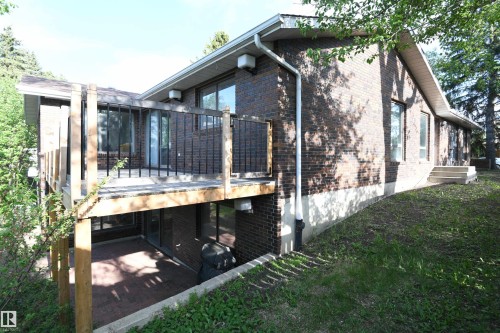 Two elevated decks serve the main floor, and create two covered patio spaces off of the walkout basement.  This deck is accessed from the dining area off the kitchen - 4108 106B Avenue, Edmonton, AB - Outdoor