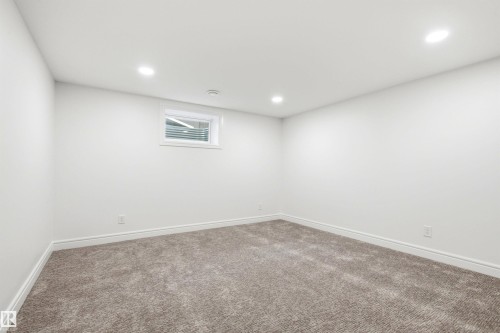 Room featuring neutral carpeting, white walls, and recessed lighting - 14335 47 Avenue Nw, Edmonton, AB - Indoor